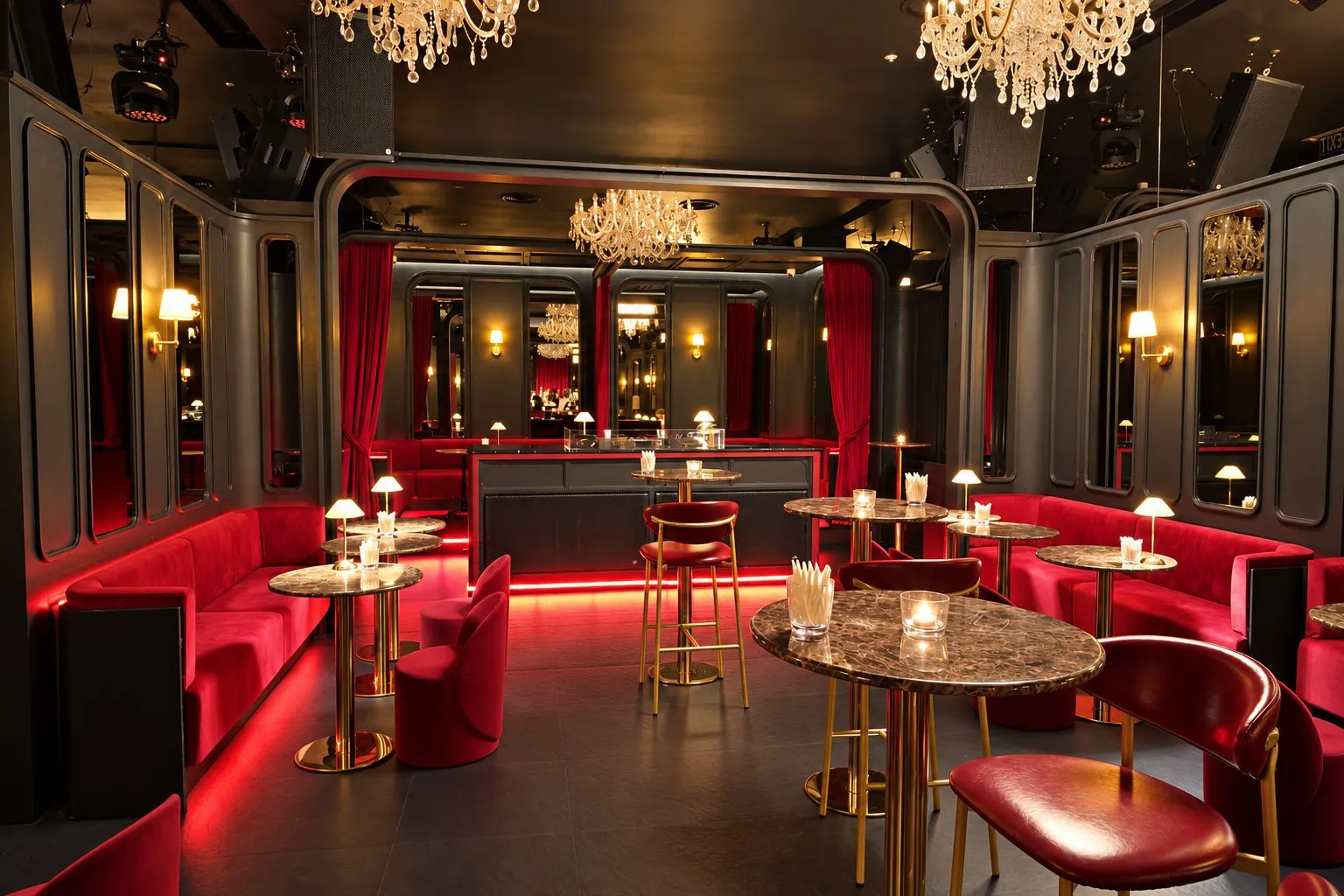 Red velvet sofas, marble high tables and table lamps in the main room